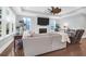 Comfortable living room featuring hardwood floors, a fireplace, and expansive windows overlooking the outdoors at 217 Quimby Hill Dr, Huger, SC 29450