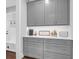 Well-organized mudroom featuring gray cabinets, drawers, and a charming decor at 217 Quimby Hill Dr, Huger, SC 29450