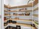 Walk-in pantry with wire shelving and some wood shelves stocked with a variety of food and kitchen items at 217 Quimby Hill Dr, Huger, SC 29450