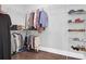 Organized walk-in closet with wood floors and metal shelving for clothes, shoes and accessories at 217 Quimby Hill Dr, Huger, SC 29450
