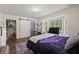 Well-lit bedroom with a sliding barn door and a view of the lush outdoors at 2170 Midland Park Rd, North Charleston, SC 29406