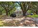 Charming gray home with a front porch framed by mature oak trees at 2170 Midland Park Rd, North Charleston, SC 29406
