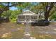 Charming gray cottage-style home with a quaint front porch and mature trees at 2170 Midland Park Rd, North Charleston, SC 29406