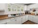 Sunlit kitchen featuring white cabinetry and a stainless steel sink at 2170 Midland Park Rd, North Charleston, SC 29406