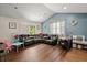 Cozy living room with modern gray walls, a vaulted ceiling, and wood floors at 2170 Midland Park Rd, North Charleston, SC 29406