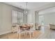Bright dining area features a stylish light fixture and a charming table set for four, perfect for cozy meals at 2404 Fulford Ct, Mount Pleasant, SC 29466