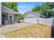 View of the detached garage next to the screened-in porch with a concrete driveway and green grass at 2404 Fulford Ct, Mount Pleasant, SC 29466