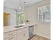Modern kitchen with quartz countertops, stainless steel appliances, and a view of the backyard through sliding doors at 2404 Fulford Ct, Mount Pleasant, SC 29466