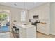 Well-lit kitchen with white cabinetry, stainless steel appliances, and a breakfast bar with seating at 2404 Fulford Ct, Mount Pleasant, SC 29466