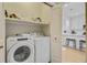 Convenient laundry area with Whirlpool appliances and storage shelf at 2404 Fulford Ct, Mount Pleasant, SC 29466