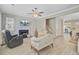 Spacious living area with modern furnishings, fireplace, a ceiling fan, and staircase access at 2404 Fulford Ct, Mount Pleasant, SC 29466