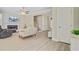Bright living room with a fireplace, ceiling fan, modern flooring, and neutral color scheme at 2404 Fulford Ct, Mount Pleasant, SC 29466