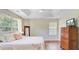 The main bedroom features a tray ceiling, wood floors, and windows with views, providing a comfortable retreat at 2404 Fulford Ct, Mount Pleasant, SC 29466