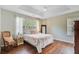 This main bedroom has wood floors, a tray ceiling, a large window, and an area rug for comfort at 2404 Fulford Ct, Mount Pleasant, SC 29466