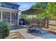 Outdoor patio featuring a dining set with an umbrella and a grill in a well-maintained backyard at 2404 Fulford Ct, Mount Pleasant, SC 29466