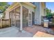 A screened in porch with brick and concrete under the porch and a grill behind it at 2404 Fulford Ct, Mount Pleasant, SC 29466