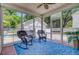 Relaxing screened-in porch with wicker rocking chairs, a patterned rug, and views of the backyard at 2404 Fulford Ct, Mount Pleasant, SC 29466