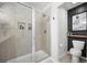 Modern bathroom featuring a sleek walk-in shower with glass doors and a floating shelf at 286 Godwit Dr, Summerville, SC 29486