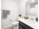 Clean bathroom with a white toilet and sink, a dark wood vanity, and neutral decor at 286 Godwit Dr, Summerville, SC 29486