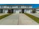 View of townhomes with driveways and garages, showing the building's structure and layout at 286 Godwit Dr, Summerville, SC 29486