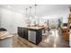 Stylish kitchen features an island with a sink, granite countertops, and is open to the living area at 286 Godwit Dr, Summerville, SC 29486