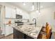 Bright kitchen features a large island with granite countertops, stainless steel appliances and modern lighting at 286 Godwit Dr, Summerville, SC 29486
