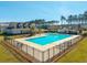 Aerial view of fenced neighborhood pool and amenity center surrounded by trees and homes at 286 Godwit Dr, Summerville, SC 29486