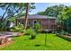 Charming backyard with lush lawn, patio, flower beds and greenery complementing the home's exterior at 31 Lyttleton Ave, Charleston, SC 29407