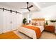 Serene bedroom offers a ceiling fan, sliding closet doors, and natural light through large window at 31 Lyttleton Ave, Charleston, SC 29407