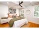 Well-lit bedroom with wood floors, ceiling fan, sleek furnishings, and natural accents at 31 Lyttleton Ave, Charleston, SC 29407