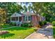 Attractive brick home with landscaped front yard, including walkway, plants, and manicured lawn at 31 Lyttleton Ave, Charleston, SC 29407