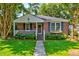 Charming brick home with a manicured lawn and inviting front porch with flower boxes at 31 Lyttleton Ave, Charleston, SC 29407