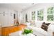Airy living room with built-in storage and door to outdoor space with plenty of light at 31 Lyttleton Ave, Charleston, SC 29407