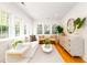 Bright, modern living room with white furnishings, hardwood floors, and oversized windows at 31 Lyttleton Ave, Charleston, SC 29407
