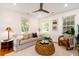 Inviting living room filled with natural light, a stylish ceiling fan, and hardwood floors at 31 Lyttleton Ave, Charleston, SC 29407