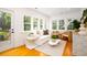 Bright sun room featuring large windows, hardwood floors, comfortable seating and decor, bathed in natural light at 31 Lyttleton Ave, Charleston, SC 29407