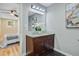 Bathroom with a double vanity, granite countertop, modern lighting, and stylish decor at 316 Simmons Ave, Summerville, SC 29483