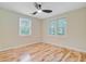 A sunlit bedroom with hardwood floors and bright windows offers a welcoming space at 316 Simmons Ave, Summerville, SC 29483