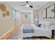 A stylish bedroom includes a queen bed, ceiling fan, built-in wardrobe, and unique wall art at 316 Simmons Ave, Summerville, SC 29483