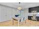 Open dining area featuring hardwood floors, dining table with seating, and modern lighting at 316 Simmons Ave, Summerville, SC 29483