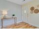 Inviting entryway with hardwood floors, decor and a console table with decorative lamp at 316 Simmons Ave, Summerville, SC 29483