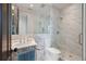 This bright bathroom features marble walls, a glass shower and elegant fixtures at 32 Prioleau St # J, Charleston, SC 29401