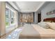 Spacious bedroom with tray ceiling, large window with natural light, light blue walls and wood flooring at 32 Prioleau St # J, Charleston, SC 29401