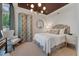 This bedroom features an upholstered bed, round mirror and unique light fixture at 32 Prioleau St # J, Charleston, SC 29401