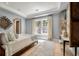 Bedroom with tray ceiling, wooden framed bed, tapestry, and lots of natural light from large window at 32 Prioleau St # J, Charleston, SC 29401