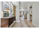 Inviting foyer with beautiful hardwood floors, neutral rug, and natural light pouring in through large windows at 32 Prioleau St # J, Charleston, SC 29401