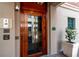 Elegant wood front door with glass panel and intercom system at residential building at 32 Prioleau St # J, Charleston, SC 29401