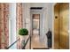Hallway with white wainscoting, hardwood floors, glass table, a view into another room and an elevator at 32 Prioleau St # J, Charleston, SC 29401