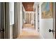 Hallway with hardwood floors, a glimpse into a bedroom and dark brown accent ceiling at 32 Prioleau St # J, Charleston, SC 29401