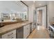 Modern kitchen with stainless steel appliances, white cabinets, and a breakfast bar at 32 Prioleau St # J, Charleston, SC 29401